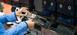 Operator bending sheet metal with machine